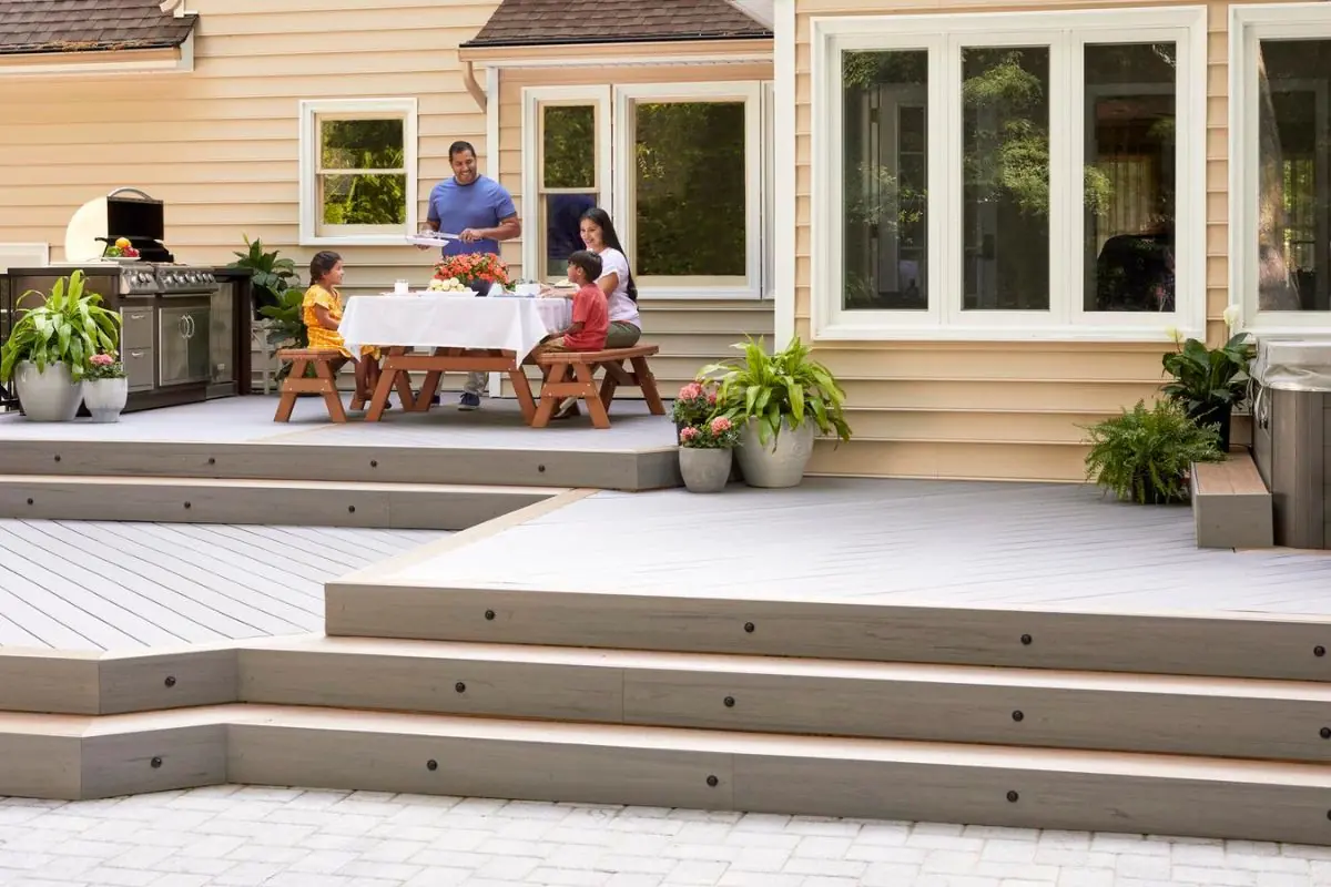 family enjoying eating on outdoor deck design