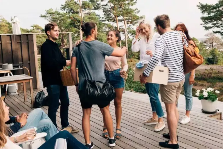 friends greeting each other on outdoor deck