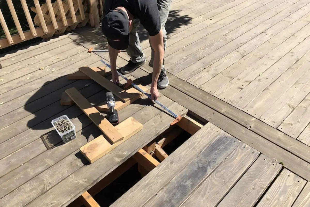 contractor repairing old wood deck