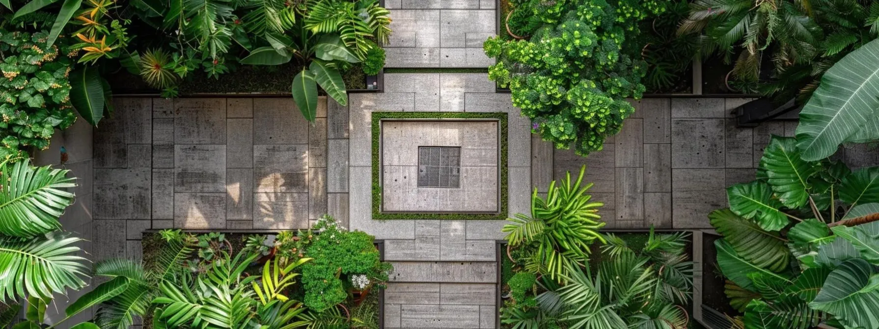 aerial view of an intricate geometric stamped concrete patio design surrounded by lush greenery